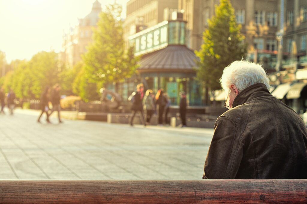 Lonely man sat on a bench