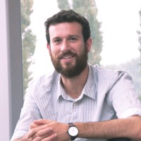Photo of Dr David Greenberg sat looking at the camera and smiling